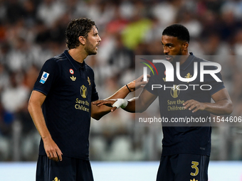 Manuel Locatelli of Juventus talks with Bremer of Juventus during the Serie A match between Juventus FC and AS Roma at Allianz Stadium in Tu...