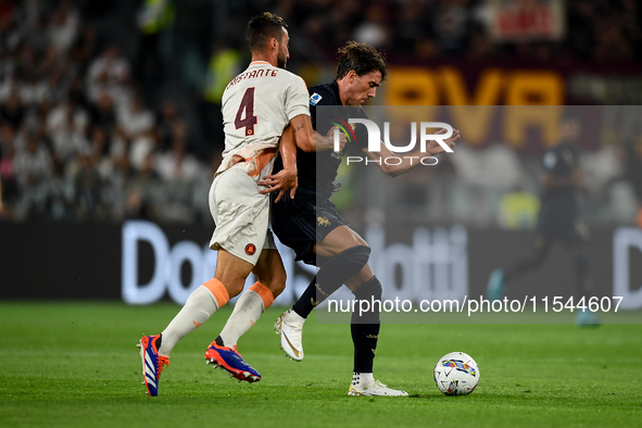 Bryan Cristante of AS Roma fights with Dusan Vlahovic of Juventus during the Serie A match between Juventus FC and AS Roma at Allianz Stadiu...