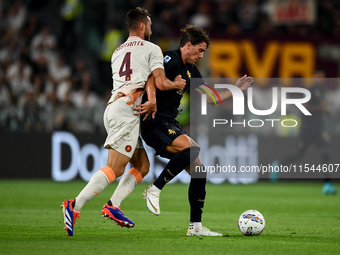 Bryan Cristante of AS Roma fights with Dusan Vlahovic of Juventus during the Serie A match between Juventus FC and AS Roma at Allianz Stadiu...