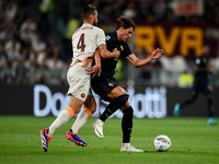 Bryan Cristante of AS Roma fights with Dusan Vlahovic of Juventus during the Serie A match between Juventus FC and AS Roma at Allianz Stadiu...