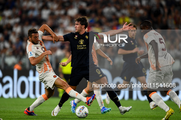 Bryan Cristante of AS Roma fights with Dusan Vlahovic of Juventus during the Serie A match between Juventus FC and AS Roma at Allianz Stadiu...