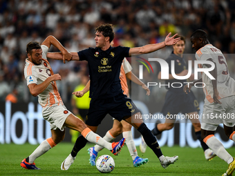 Bryan Cristante of AS Roma fights with Dusan Vlahovic of Juventus during the Serie A match between Juventus FC and AS Roma at Allianz Stadiu...