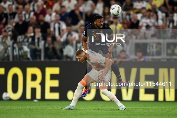 Bremer of Juventus fights for the ball with Artem Dovbyk of AS Roma during the Serie A match between Juventus FC and AS Roma at Allianz Stad...