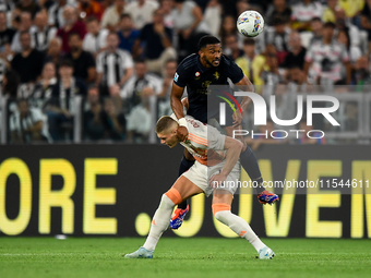 Bremer of Juventus fights for the ball with Artem Dovbyk of AS Roma during the Serie A match between Juventus FC and AS Roma at Allianz Stad...