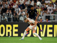 Bremer of Juventus fights for the ball with Artem Dovbyk of AS Roma during the Serie A match between Juventus FC and AS Roma at Allianz Stad...