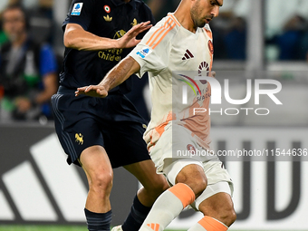 Kenan Yildiz of Juventus contends the ball with Bryan Cristante of AS Roma during the Serie A match between Juventus FC and AS Roma at Allia...