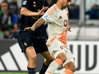 Kenan Yildiz of Juventus contends the ball with Bryan Cristante of AS Roma during the Serie A match between Juventus FC and AS Roma at Allia...