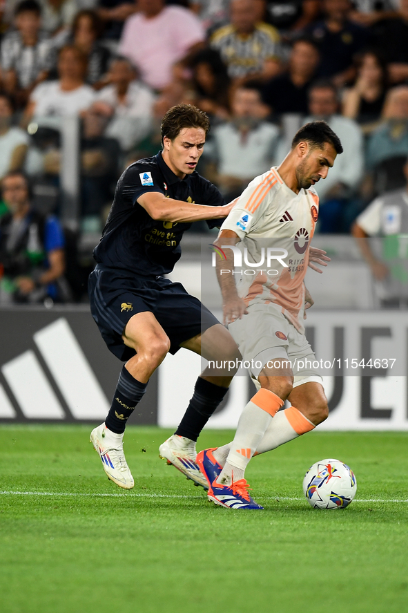 Kenan Yildiz of Juventus contends the ball with Bryan Cristante of AS Roma during the Serie A match between Juventus FC and AS Roma at Allia...