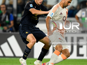 Kenan Yildiz of Juventus contends the ball with Bryan Cristante of AS Roma during the Serie A match between Juventus FC and AS Roma at Allia...