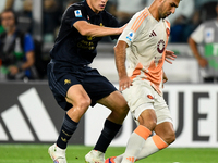 Kenan Yildiz of Juventus contends the ball with Bryan Cristante of AS Roma during the Serie A match between Juventus FC and AS Roma at Allia...