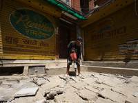 A construction worker drills around the walkways in Kathmandu, Nepal, on August 4, 2024. (