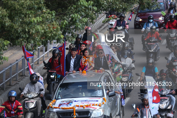 Nepali para athlete and first bronze medalist in Paralympics in Nepal's history, Palesha Goverdhan (center), is toured around the city in a...