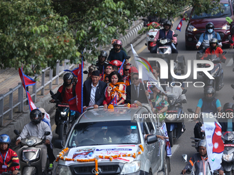 Nepali para athlete and first bronze medalist in Paralympics in Nepal's history, Palesha Goverdhan (center), is toured around the city in a...