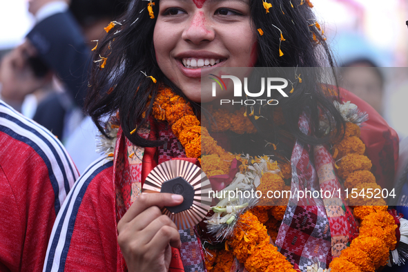 Nepali para athlete and first bronze medalist in Paralympics in Nepal's history, Palesha Goverdhan, poses for a photo along with her medal a...