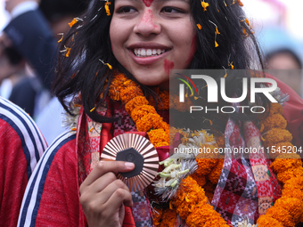 Nepali para athlete and first bronze medalist in Paralympics in Nepal's history, Palesha Goverdhan, poses for a photo along with her medal a...