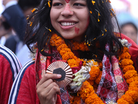 Nepali para athlete and first bronze medalist in Paralympics in Nepal's history, Palesha Goverdhan, poses for a photo along with her medal a...