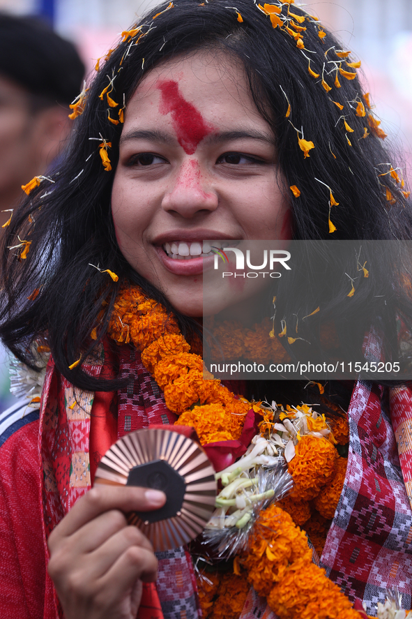 Nepali para athlete and first bronze medalist in Paralympics in Nepal's history, Palesha Goverdhan, poses for a photo along with her medal a...