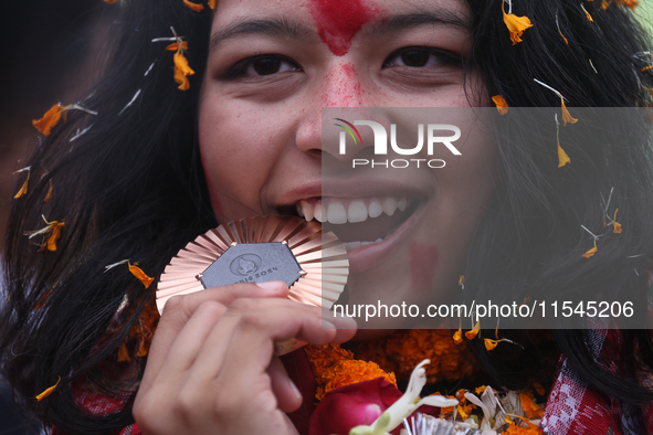 Nepali para athlete and first bronze medalist in Paralympics in Nepal's history, Palesha Goverdhan, poses for a photo along with her medal a...