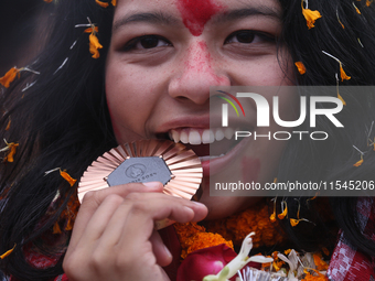 Nepali para athlete and first bronze medalist in Paralympics in Nepal's history, Palesha Goverdhan, poses for a photo along with her medal a...