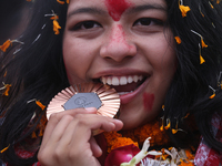 Nepali para athlete and first bronze medalist in Paralympics in Nepal's history, Palesha Goverdhan, poses for a photo along with her medal a...