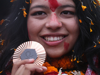 Nepali para athlete and first bronze medalist in Paralympics in Nepal's history, Palesha Goverdhan, poses for a photo along with her medal a...