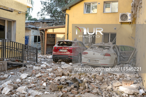 Two cars are crushed by the rubble in the Zaliznychnyi district after the Russian missile attack in Lviv, Ukraine, on September 4, 2024. In...