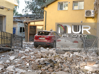 Two cars are crushed by the rubble in the Zaliznychnyi district after the Russian missile attack in Lviv, Ukraine, on September 4, 2024. In...