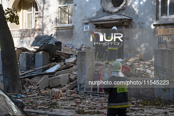 Rescuers remove the rubble at a residential building on Yevhena Konovaltsia Street after the Russian missile attack in Lviv, Ukraine, on Sep...