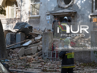 Rescuers remove the rubble at a residential building on Yevhena Konovaltsia Street after the Russian missile attack in Lviv, Ukraine, on Sep...