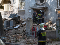 Rescuers remove the rubble at a residential building on Yevhena Konovaltsia Street after the Russian missile attack in Lviv, Ukraine, on Sep...