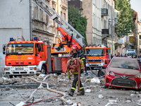 A firefighter carries a hose during a response effort to the Russian missile attack in the Zaliznychnyi district of Lviv, Ukraine, on Septem...