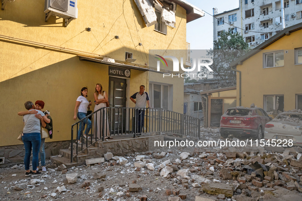 People stay outside a hotel in the Zaliznychnyi district after the Russian missile attack in Lviv, Ukraine, on September 4, 2024. In the ear...