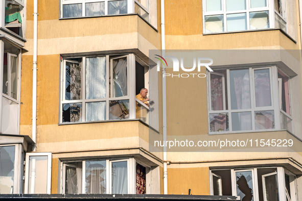 A man stands in the window broken by the shock wave from the Russian missile attack in the Zaliznychnyi district of Lviv, Ukraine, on Septem...