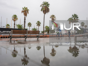 Tourists and locals walk through the city on a rainy September morning in Barcelona, Spain, on September 4, 2024. These first two weeks of S...