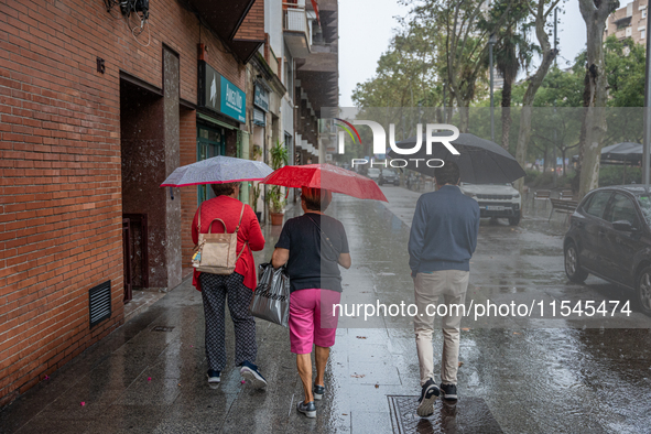 Tourists and locals walk through the city on a rainy September morning in Barcelona, Spain, on September 4, 2024. These first two weeks of S...