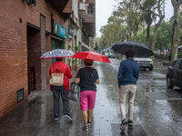 Tourists and locals walk through the city on a rainy September morning in Barcelona, Spain, on September 4, 2024. These first two weeks of S...