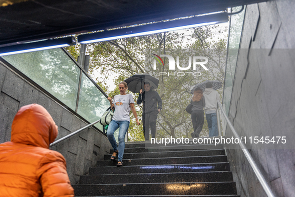 Tourists and locals walk through the city on a rainy September morning in Barcelona, Spain, on September 4, 2024. These first two weeks of S...