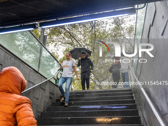 Tourists and locals walk through the city on a rainy September morning in Barcelona, Spain, on September 4, 2024. These first two weeks of S...