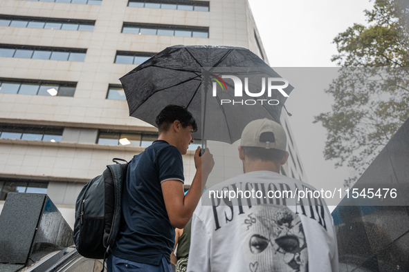 Tourists and locals walk through the city on a rainy September morning in Barcelona, Spain, on September 4, 2024. These first two weeks of S...