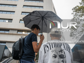 Tourists and locals walk through the city on a rainy September morning in Barcelona, Spain, on September 4, 2024. These first two weeks of S...