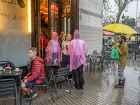 Tourists and locals walk through the city on a rainy September morning in Barcelona, Spain, on September 4, 2024. These first two weeks of S...