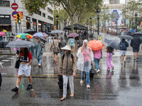 Tourists and locals walk through the city on a rainy September morning in Barcelona, Spain, on September 4, 2024. These first two weeks of S...