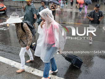 Tourists and locals walk through the city on a rainy September morning in Barcelona, Spain, on September 4, 2024. These first two weeks of S...