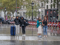 Tourists and locals walk through the city on a rainy September morning in Barcelona, Spain, on September 4, 2024. These first two weeks of S...