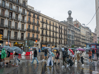 Tourists and locals walk through the city on a rainy September morning in Barcelona, Spain, on September 4, 2024. These first two weeks of S...