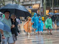 Tourists and locals walk through the city on a rainy September morning in Barcelona, Spain, on September 4, 2024. These first two weeks of S...