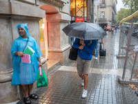 Tourists and locals walk through the city on a rainy September morning in Barcelona, Spain, on September 4, 2024. These first two weeks of S...