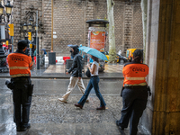 Tourists and locals walk through the city on a rainy September morning in Barcelona, Spain, on September 4, 2024. These first two weeks of S...