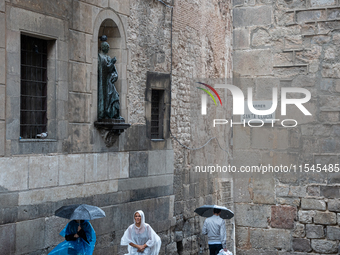 Tourists and locals walk through the city on a rainy September morning in Barcelona, Spain, on September 4, 2024. These first two weeks of S...