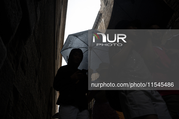 Tourists and locals walk through the city on a rainy September morning in Barcelona, Spain, on September 4, 2024. These first two weeks of S...